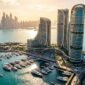 Aerial photograph of ultra-luxury coastal residential towers on the Dubai Maritime City peninsula.