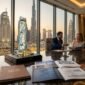 Executive private wealth advisory in Dubai reviewing architectural tower models and off-plan capital growth metrics.