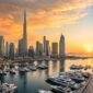 Panoramic view of Dubai skyline, Burj Khalifa and luxury yacht marina at sunset