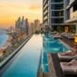 Luxury high-rise rooftop infinity pool overlooking Dubai Marina beachfront and coastline