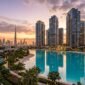 Sobha Hartland 2 crystal lagoon and luxury high-rise towers reflecting Downtown Dubai skyline at sunset