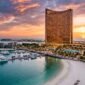 Wynn Al Marjan Island luxury casino resort tower, marina, and beachfront residences at sunset in Ras Al Khaimah